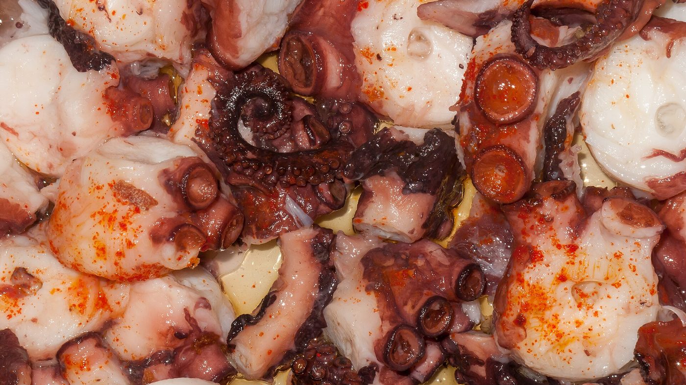 Pulpo á feira, octopus with paprika on a wooden plate